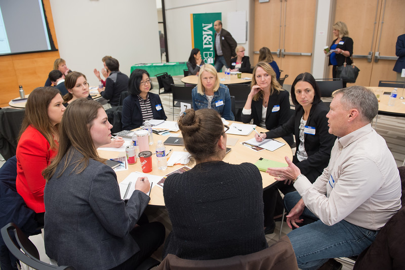 Conference attendings talking around table